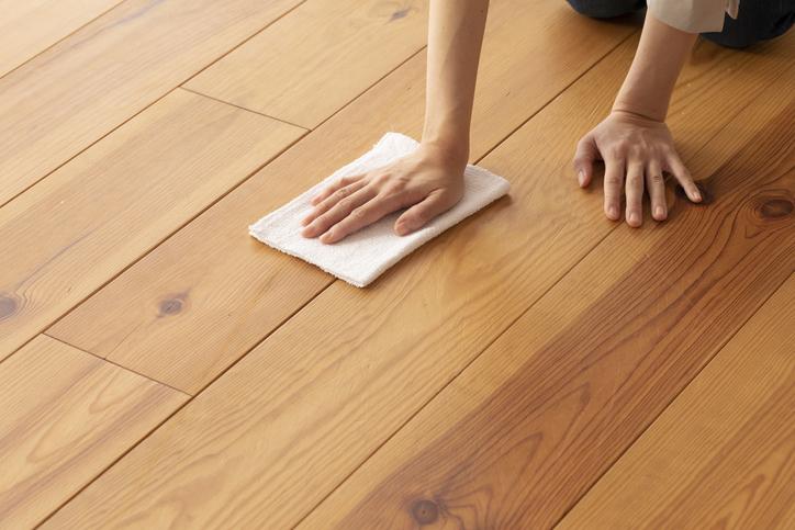 A person is wiping the hardwood floor.